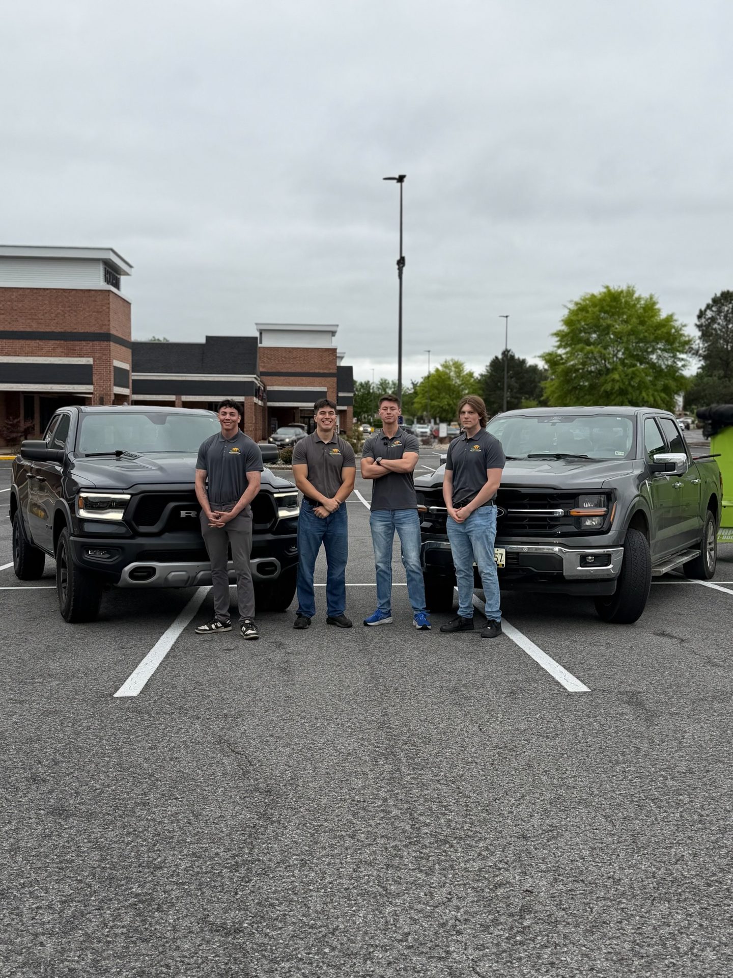 The Critters & Clutter junk removal team with company trucks in Southern Maryland