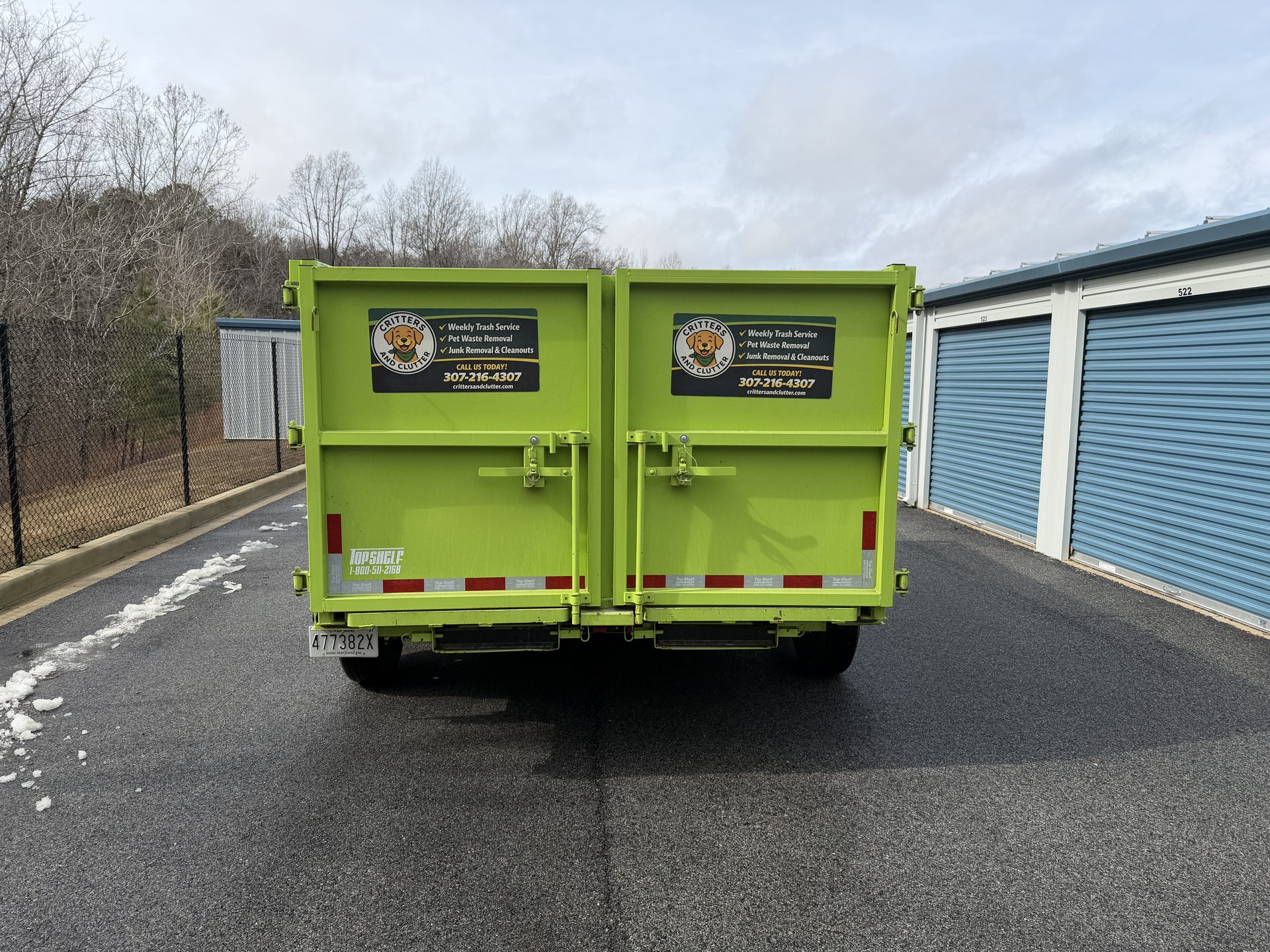 Critters & Clutter green dump trailer used for junk removal in Southern Maryland
