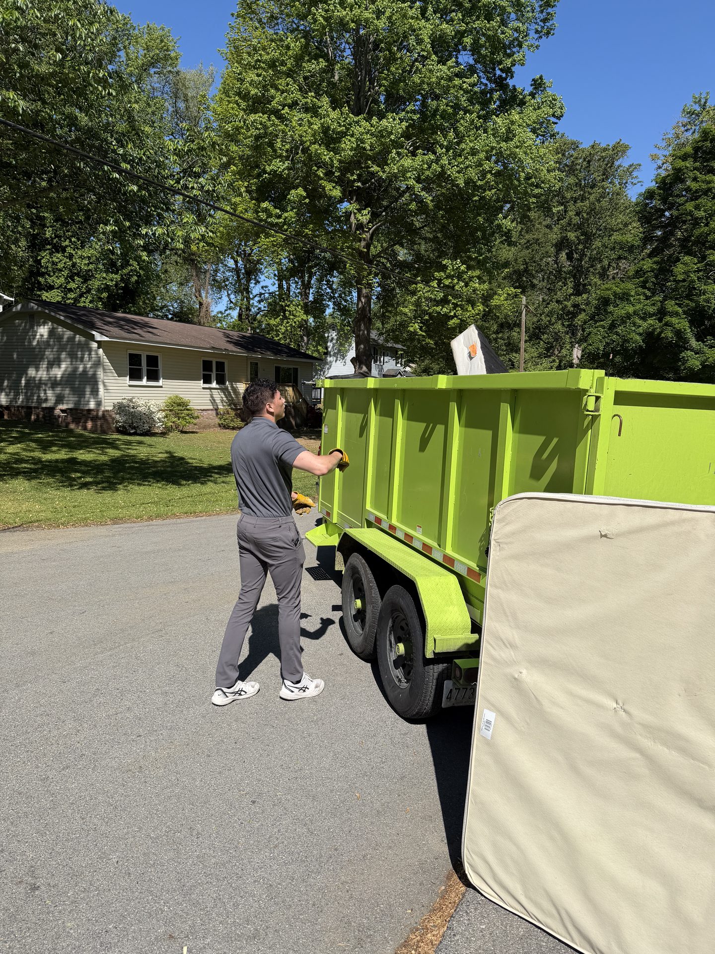 Critters & Clutter crew loading heavy items during a junk removal job