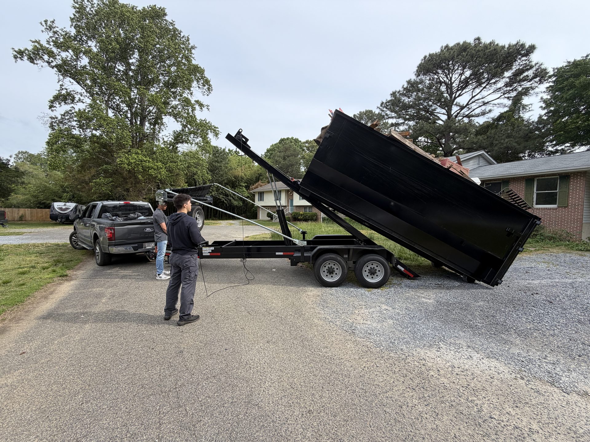Critters & Clutter trailer unloading a full junk removal haul in Maryland